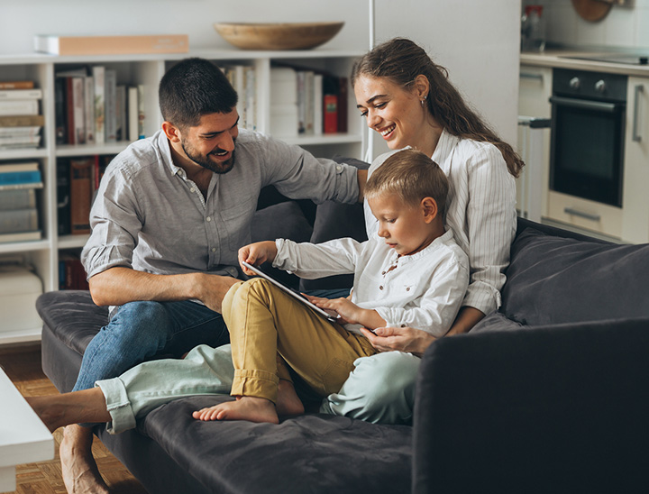 Image of young family sitting in the living room of their new home.