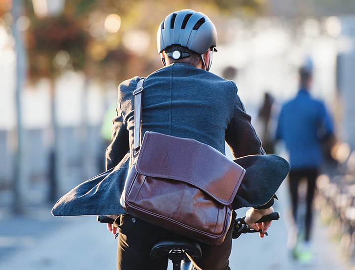 Image of person cycling to work on a cycle path.